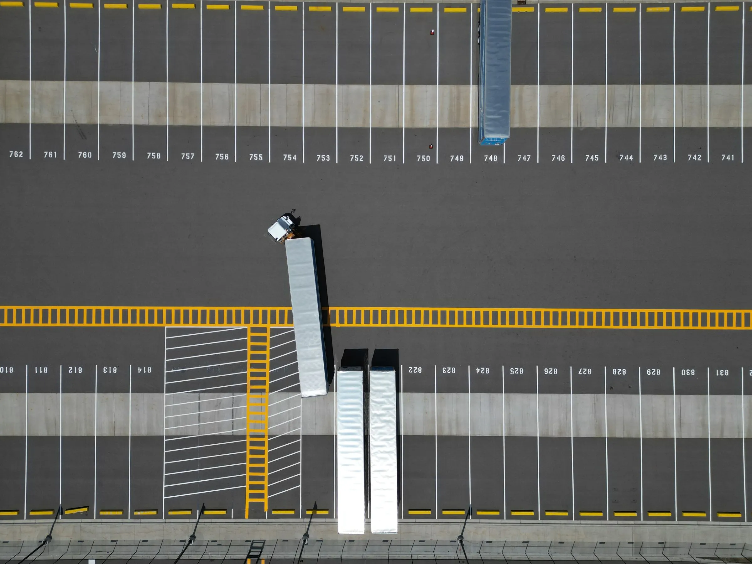 Trailers in numbered loading bays, seen from above